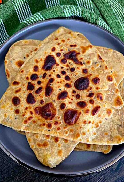 Hot, golden-brown Tawa Triangular Paratha freshly cooked and ready for serving.