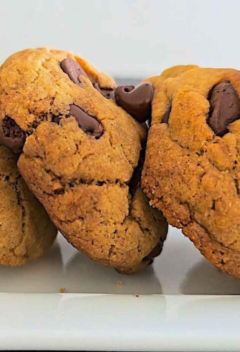 Close-up shot of freshly baked chocolate chip cookies with melted chocolate chunks.