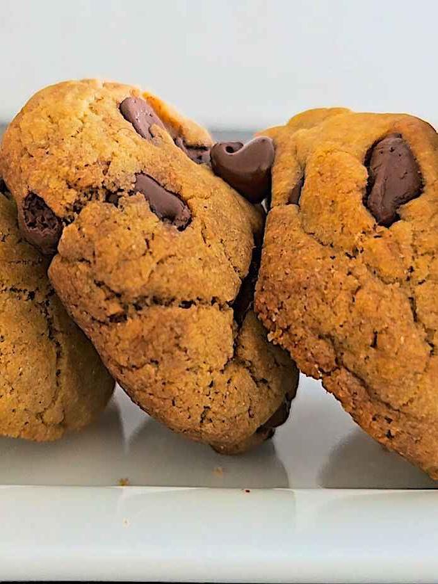 Close-up shot of freshly baked chocolate chip cookies with melted chocolate chunks.