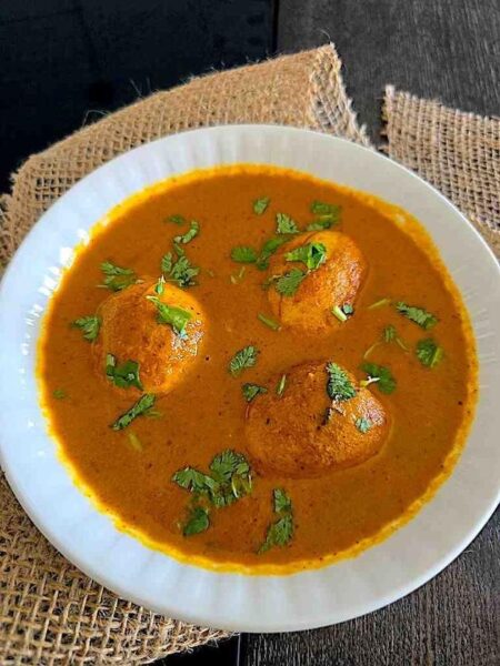 A close-up of the finished egg curry, showcasing the vibrant colors and texture of the dish.