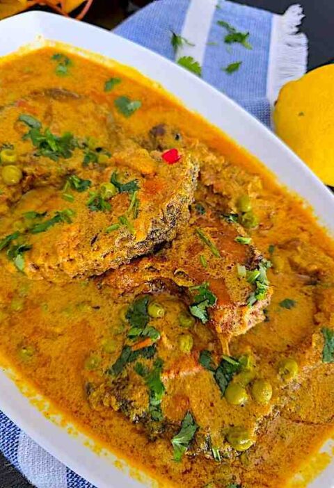 Freshly prepared fish curry served in a platter, garnished and ready to enjoy