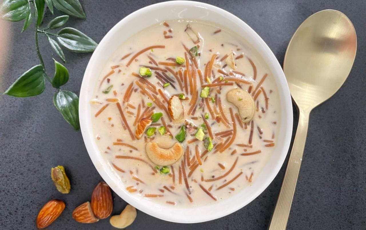 Seviyan – Indian vermicelli dessert garnished with nuts and raisins, served in a bowl.